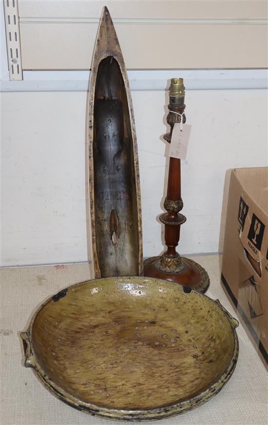 An Alsace pottery baking dish, mahogany table lamp and a boat hull